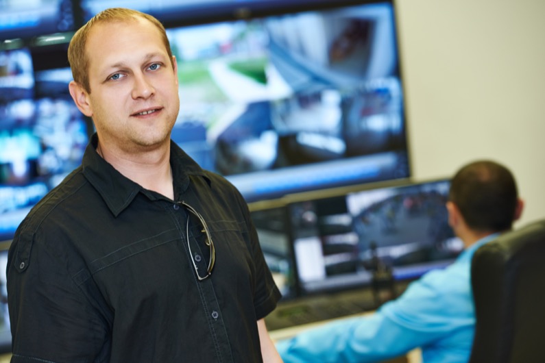 security executive chief in front of video monitoring surveillance security system