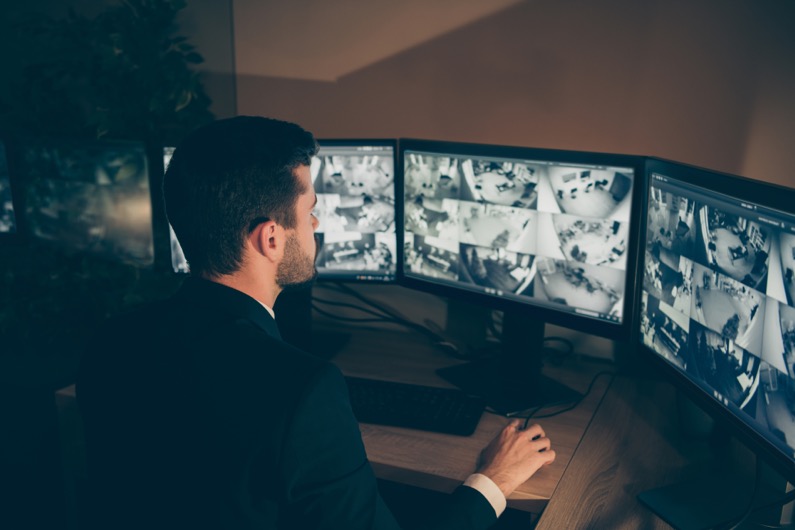 Profile side view portrait of nice serious web specialist supervising alarm panel night shift calling online information technical support