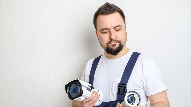 Technician or contractor choosing CCTV security camera