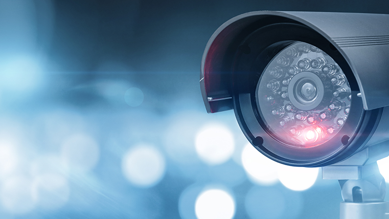 Close up of CCTV camera over defocused background with copy space