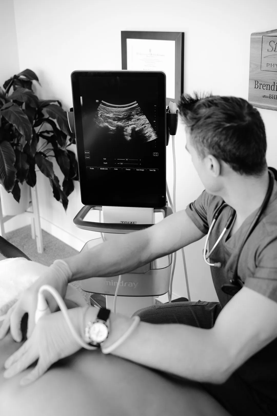 Medical professional performs an ultrasound exam on a patient using a Mindray machine.