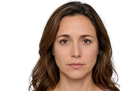 Neutral expression woman with slight asymmetry in her eyebrows and shoulder-length brown hair.