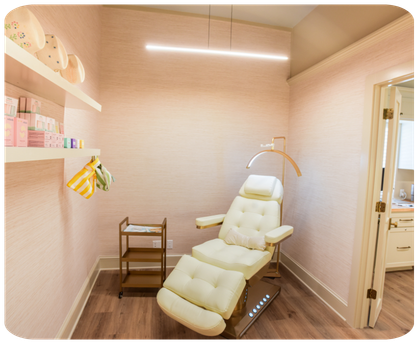 Modern reclining chair in a minimalist spa room with shelves holding skincare products.