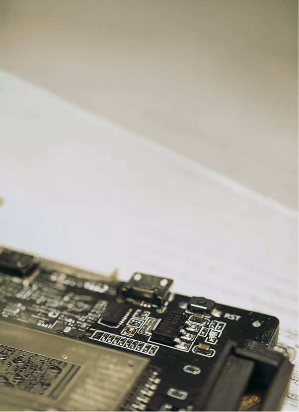 Close-up of a black circuit board with electronic components and a USB port.