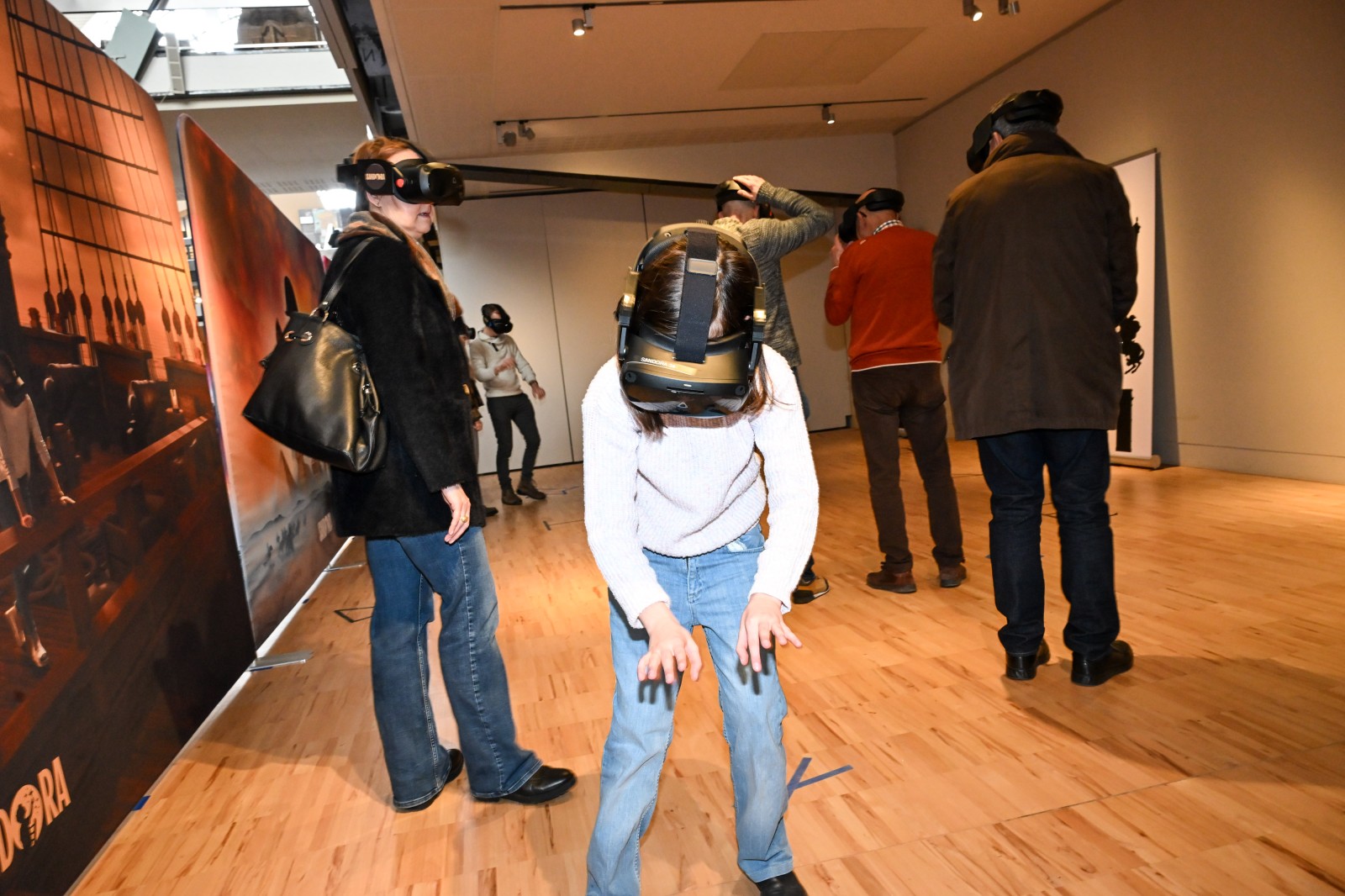 Adultes et enfant avec des casques de réalité virtuelle pour l'exposition Napoléon