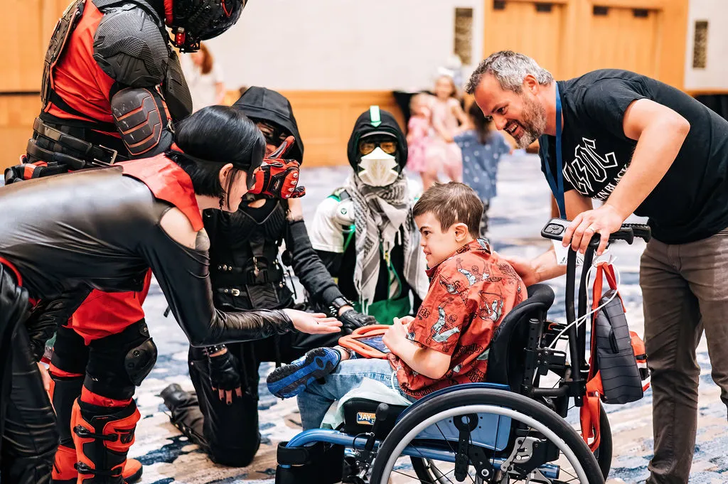 A Retreat attendee using a wheelchair connects with others at the event