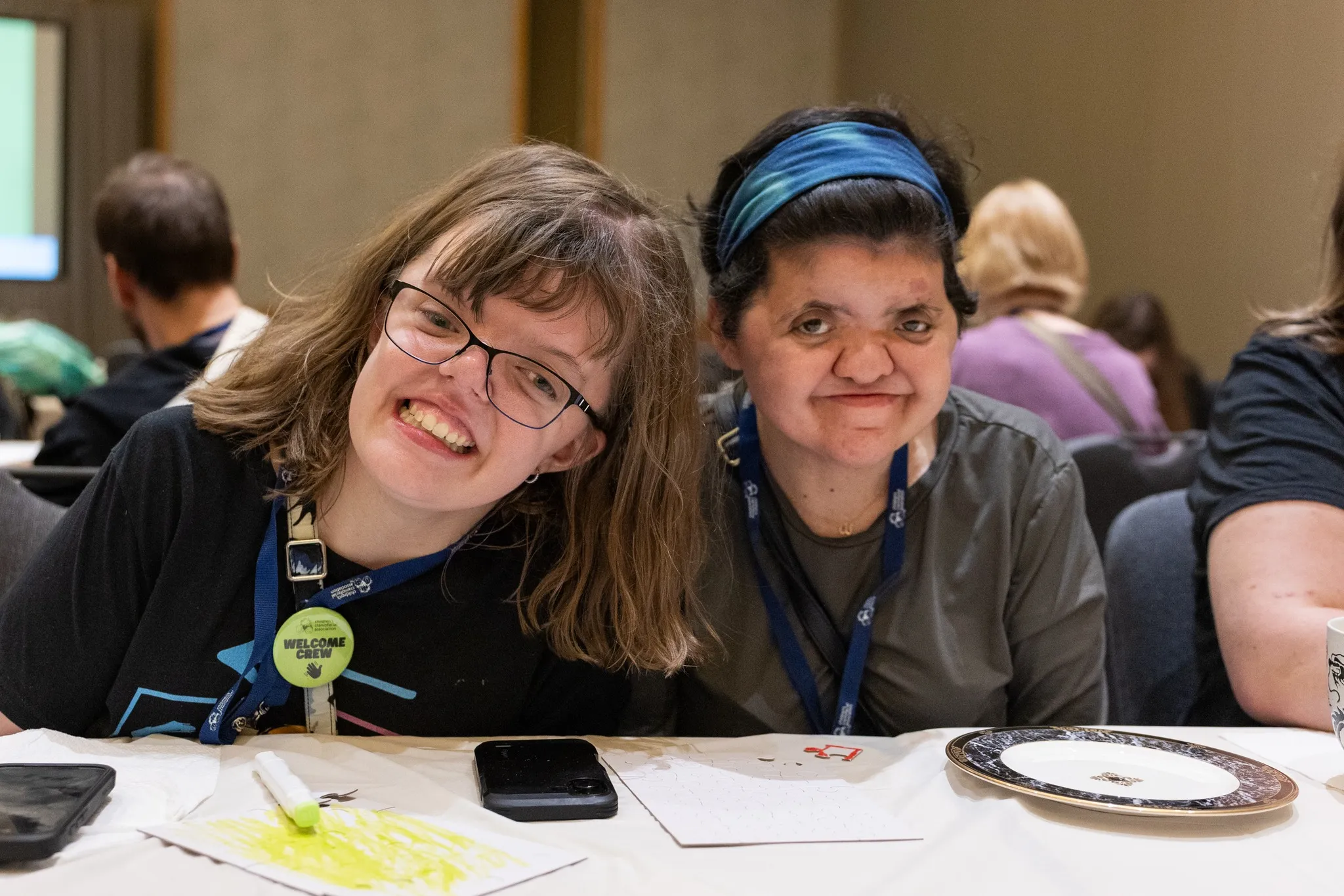 Two women smile together at a CCA event