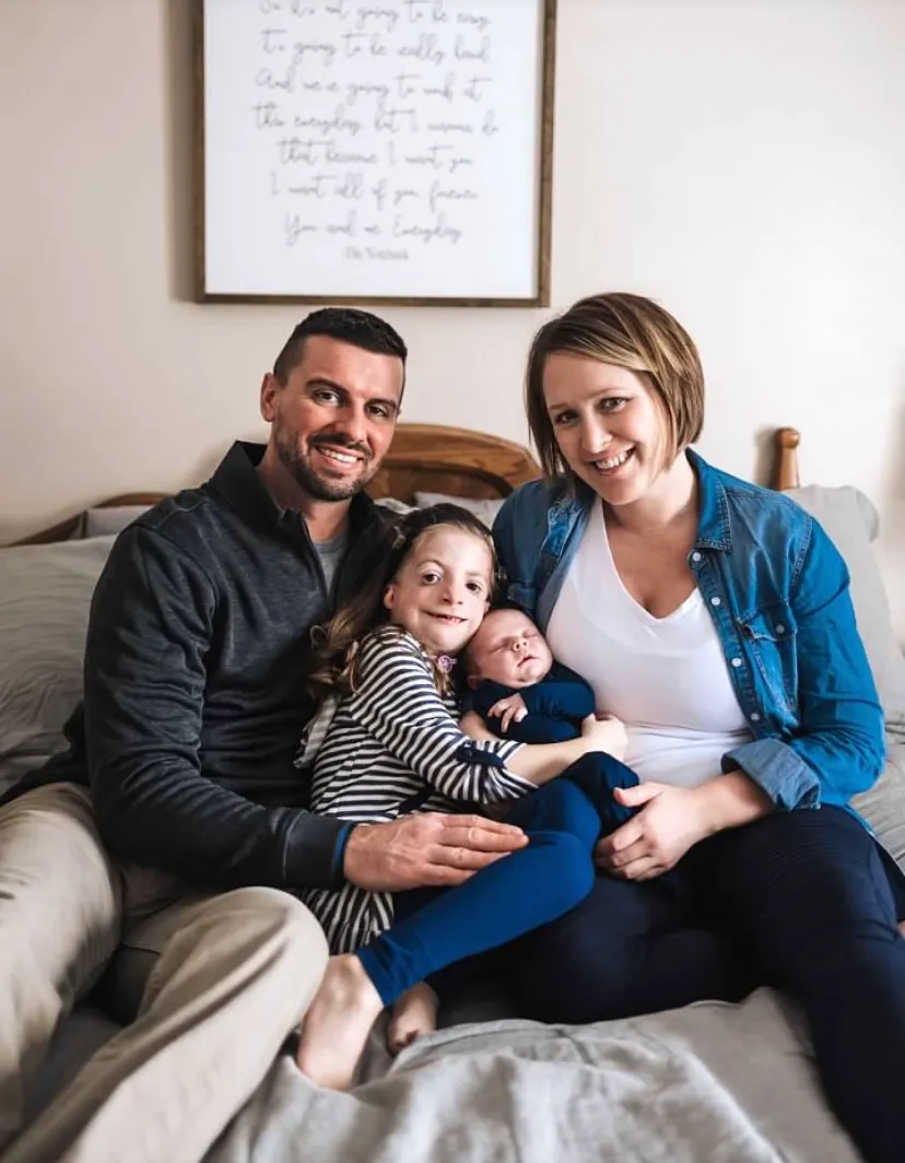 Whitney and her family - mother, father — smiling together at home