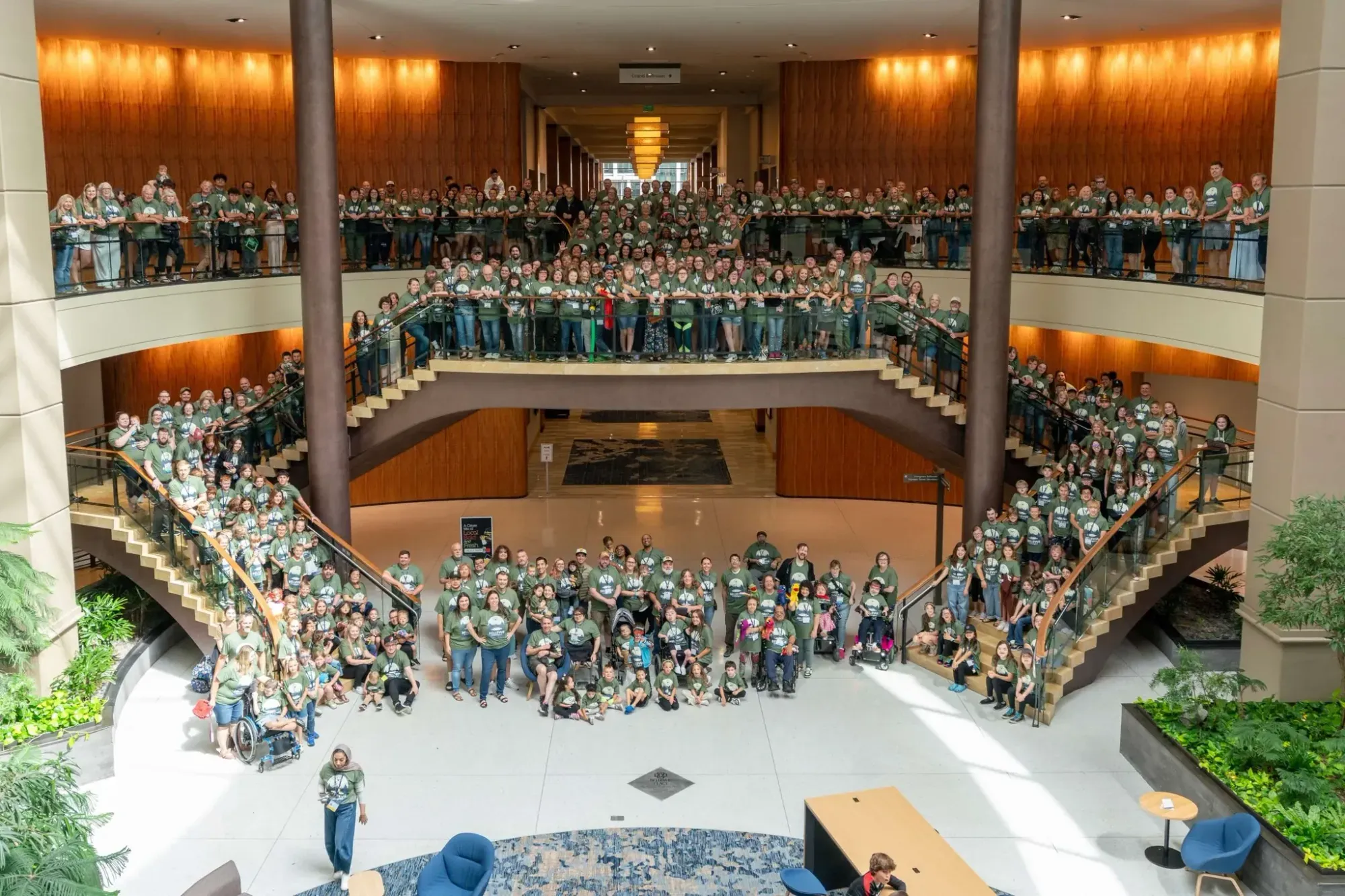 Aerial view of families gathered in a hotel atrium at the Annual Retreat