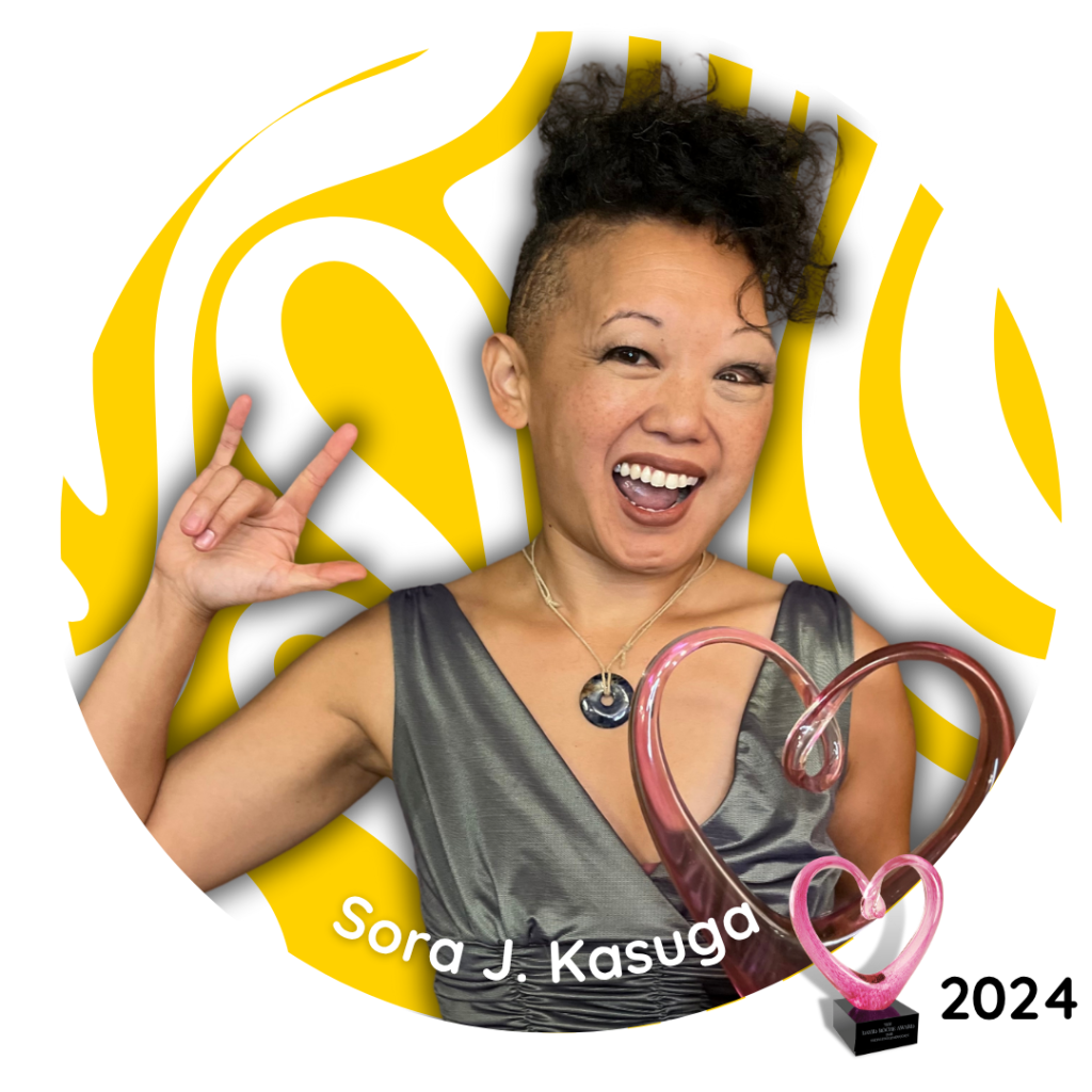 Sora J. Kasuga, 2024 David Roche Award recipient, smiling with a peace sign gesture