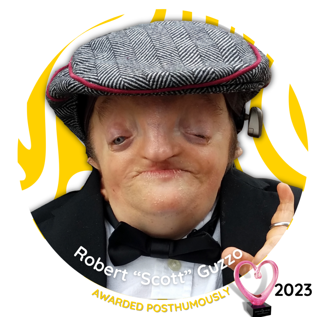 Robert "Scott" Guzzo, 2023 David Roche Award recipient, awarded posthumously — portrait wearing a flat cap and bow tie