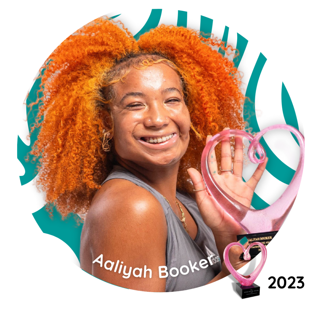 Aaliyah Booker, 2023 David Roche Award recipient, smiling and holding the award trophy