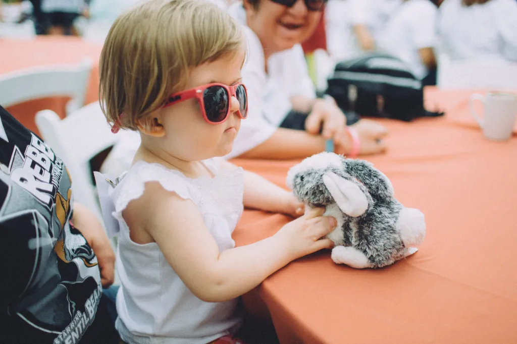 A child plays at an outdoor table during a CCA event