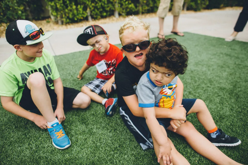 Children play together outdoors at a CCA event