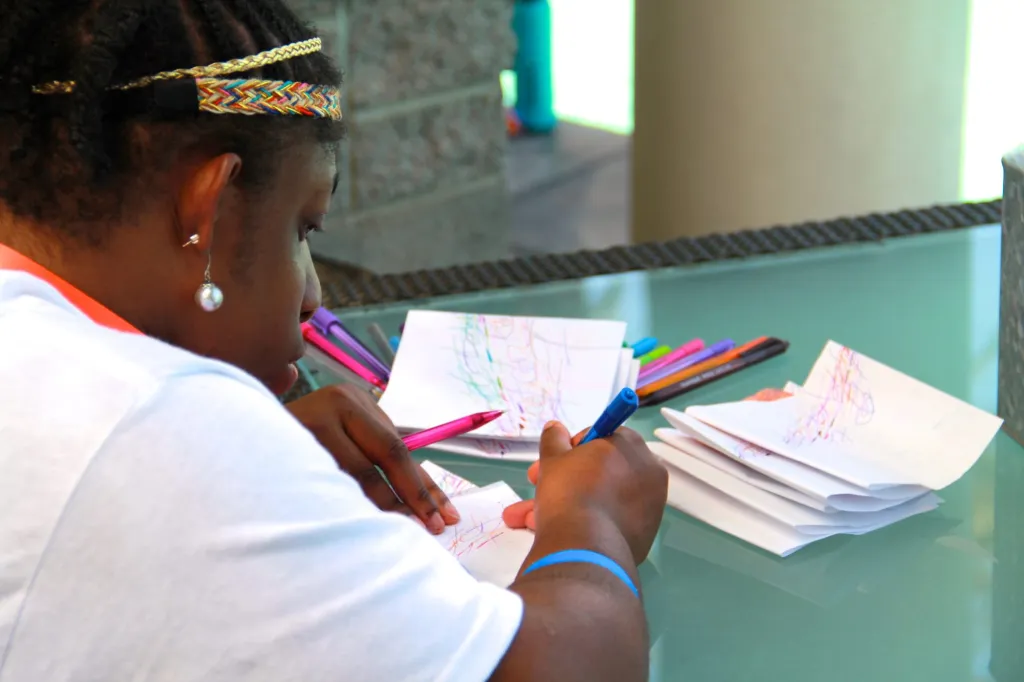 A CCA volunteer helps with event check-in