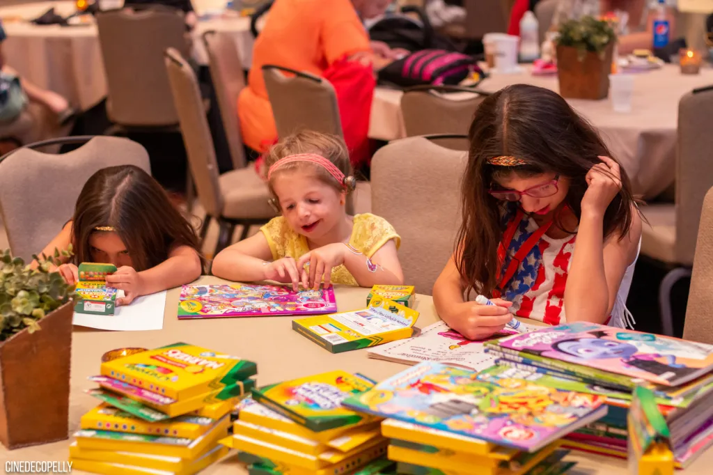 Families gather around an activity table at a CCA event