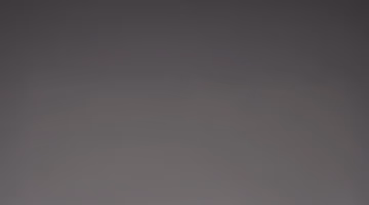 Smooth gradient background blending dark and light gray tones.