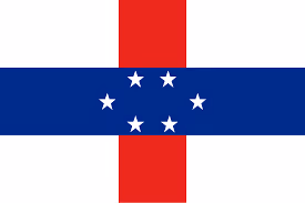 Flag with a vertical red stripe and horizontal dark blue stripe intersecting at center with seven white stars.