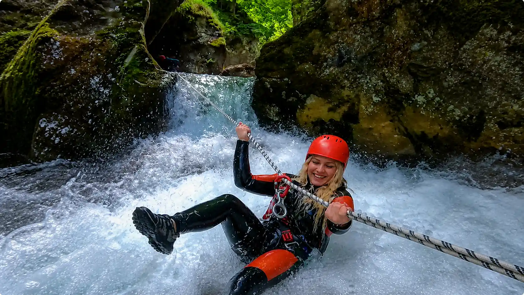 Girl rappelling down waterfall canyoning Hrcavka Bosnia
