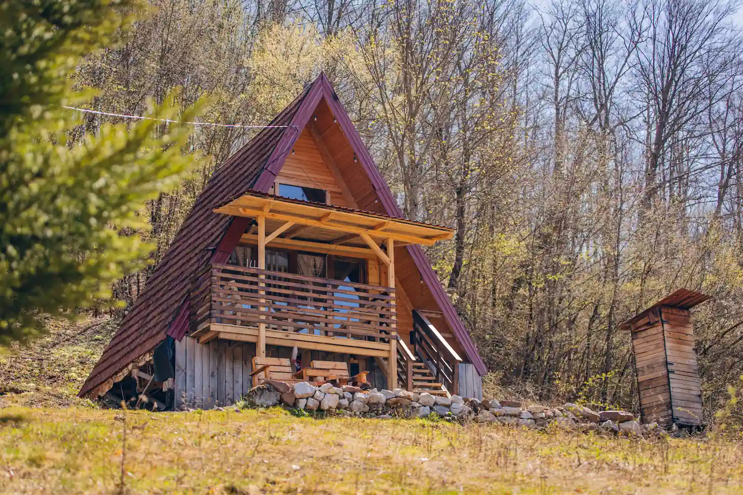 A-frame cabin with terrace during the day