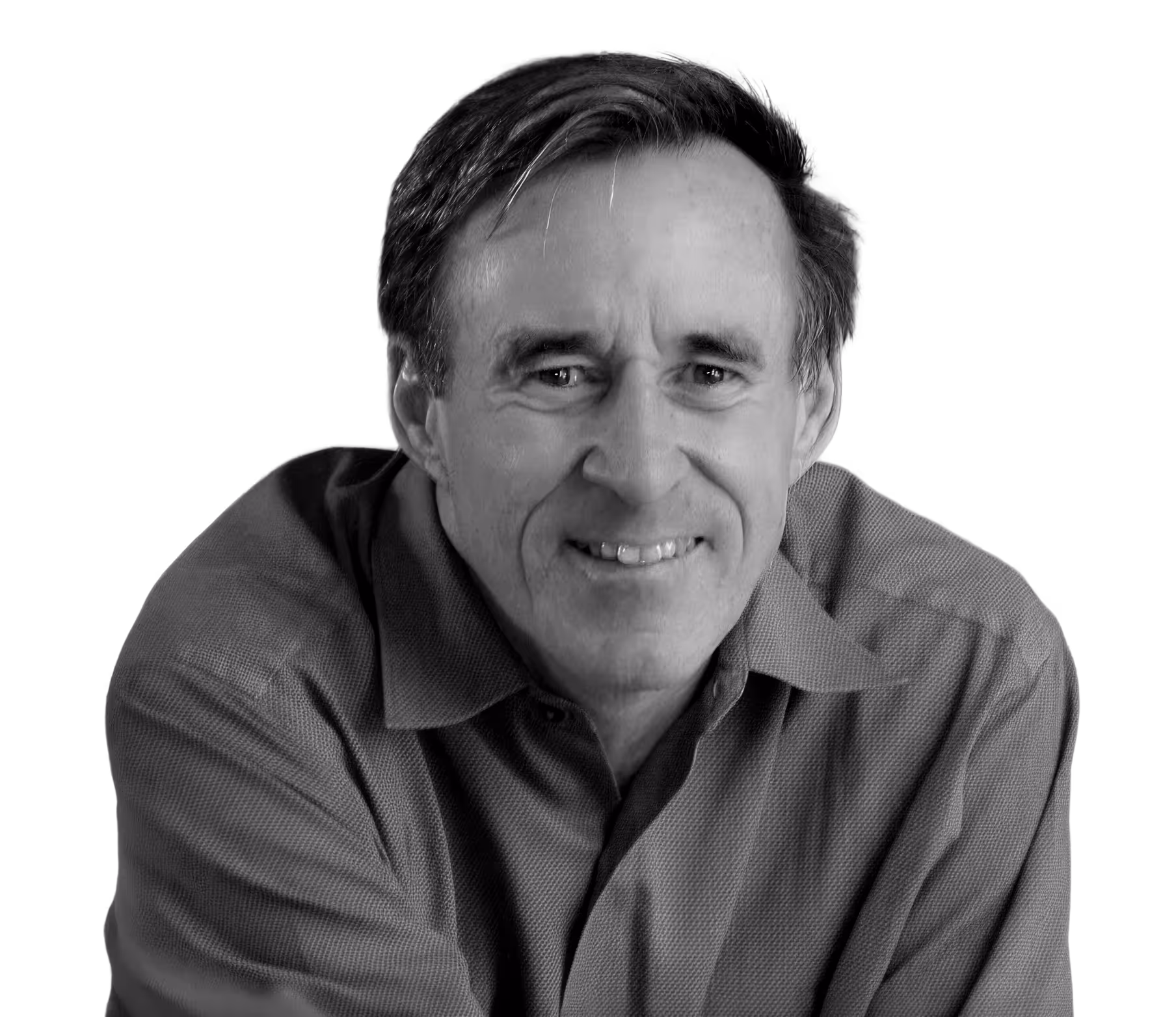 Smiling middle-aged man with short hair wearing a collared shirt, posed against a black background.