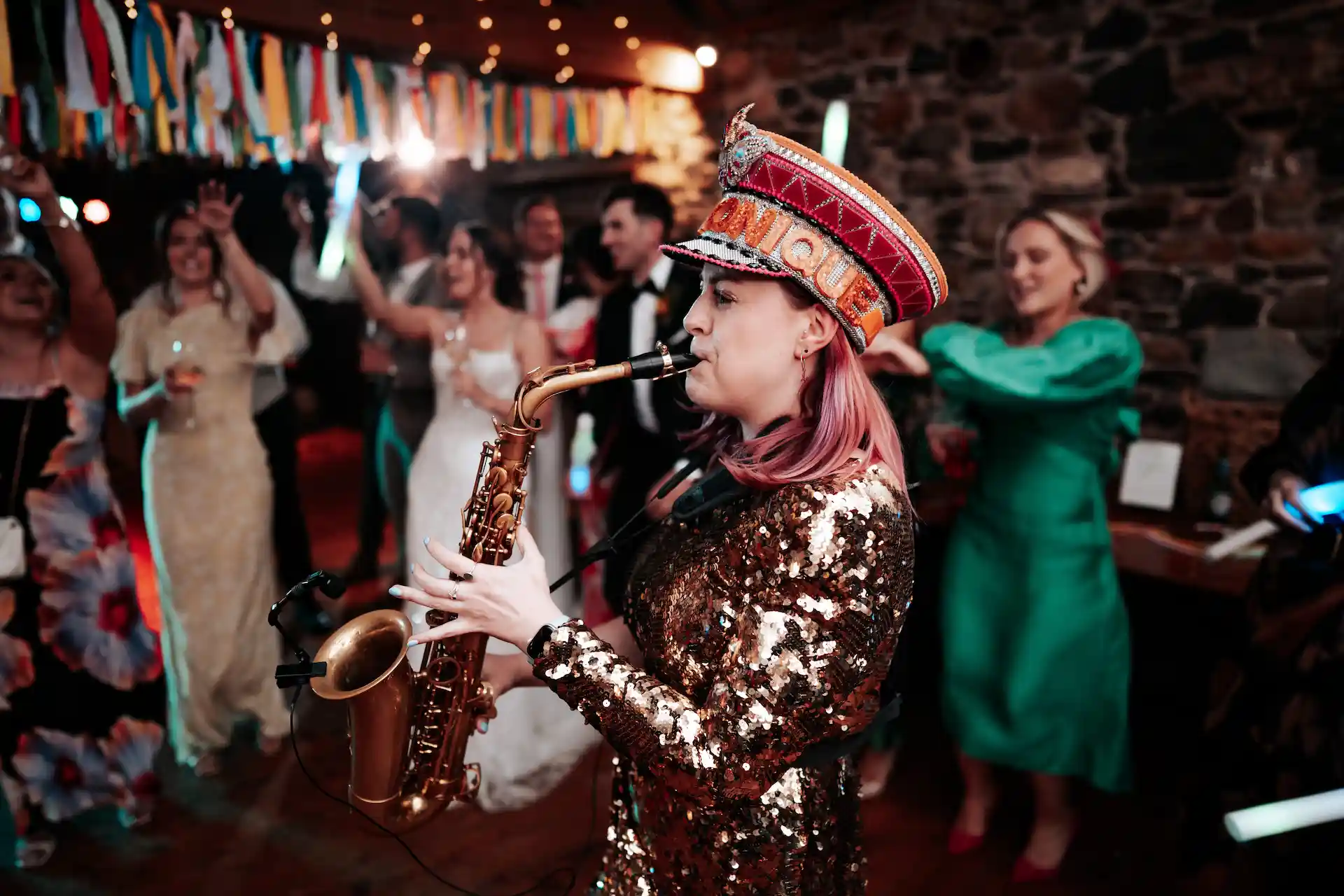 saxophonique at a wedding with a bride in the background, at low hall in the lake district