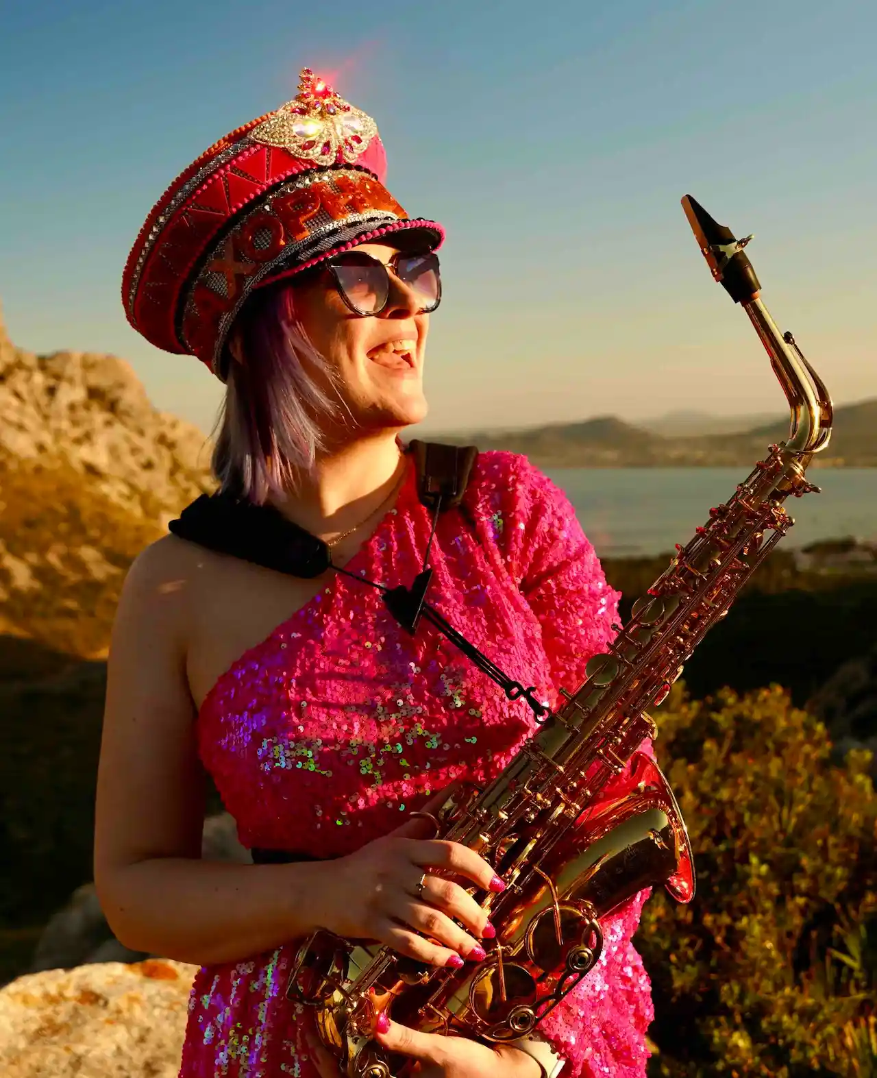 saxophonique standing on a hill top in mallorca daytime saxophone