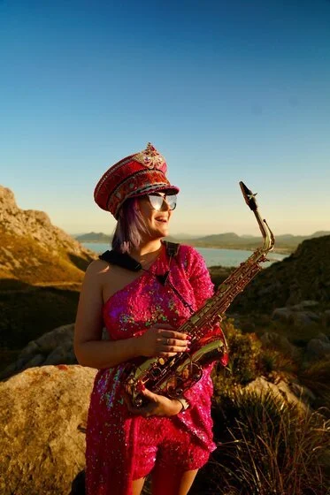 saxophonique standing in the sunshine golden hour in mallorca