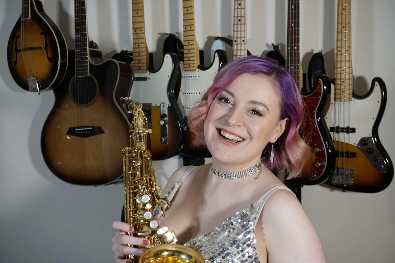 cat from saxophonique at pickering street studios holding her saxophone