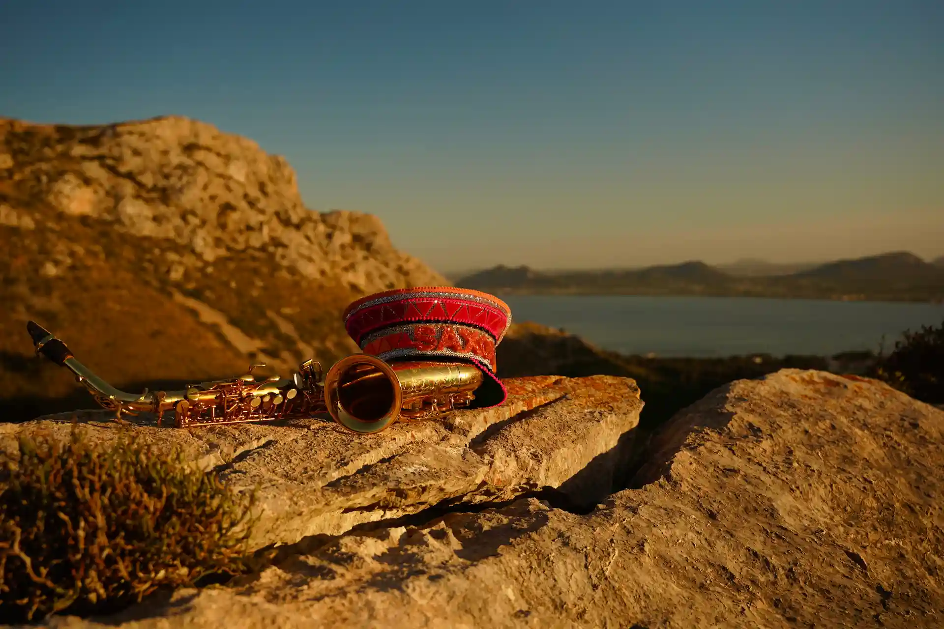 cat's hat and saxophone on a hill in mallorca golden hour