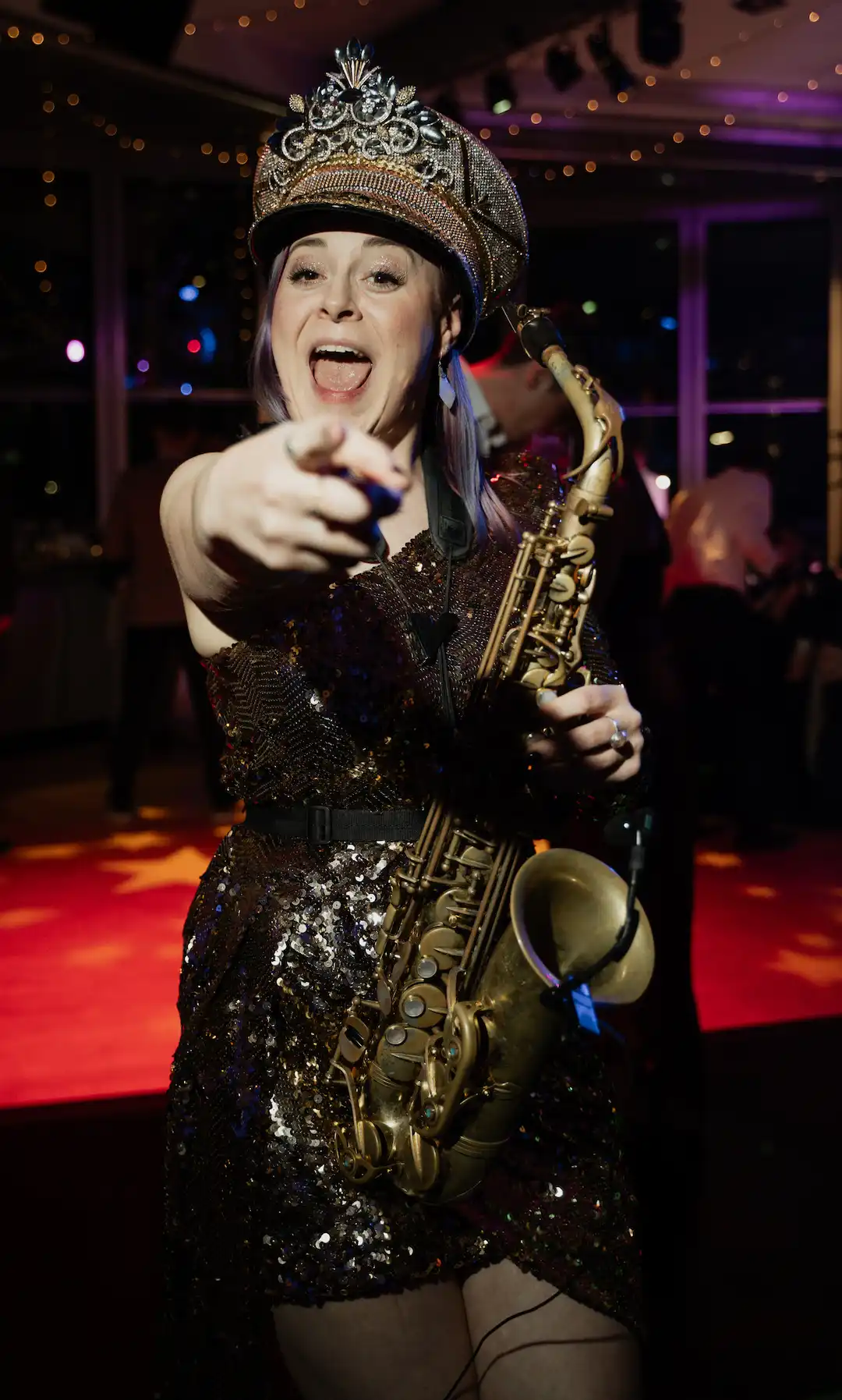 cat from saxophonique at a wedding pointing at the camera at a wedding