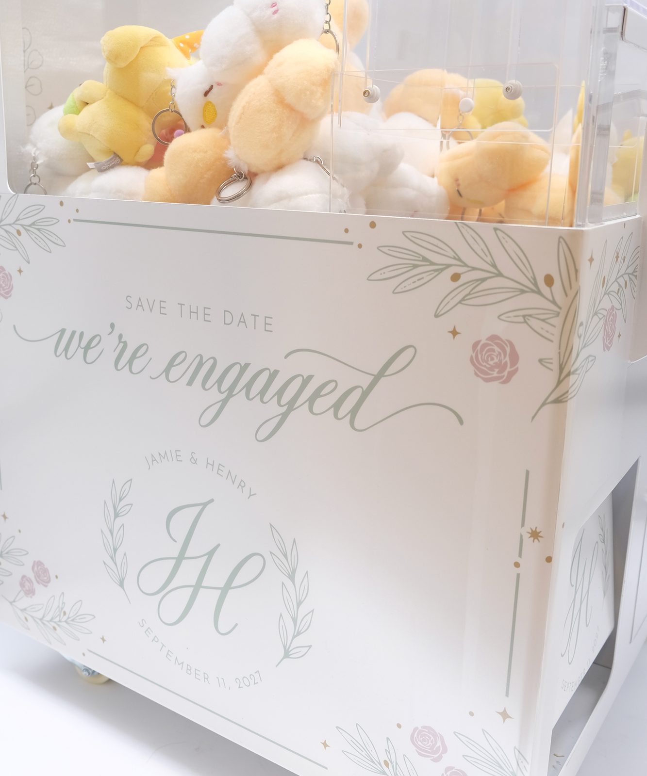 Custom wedding-wrapped claw machine full of plushies