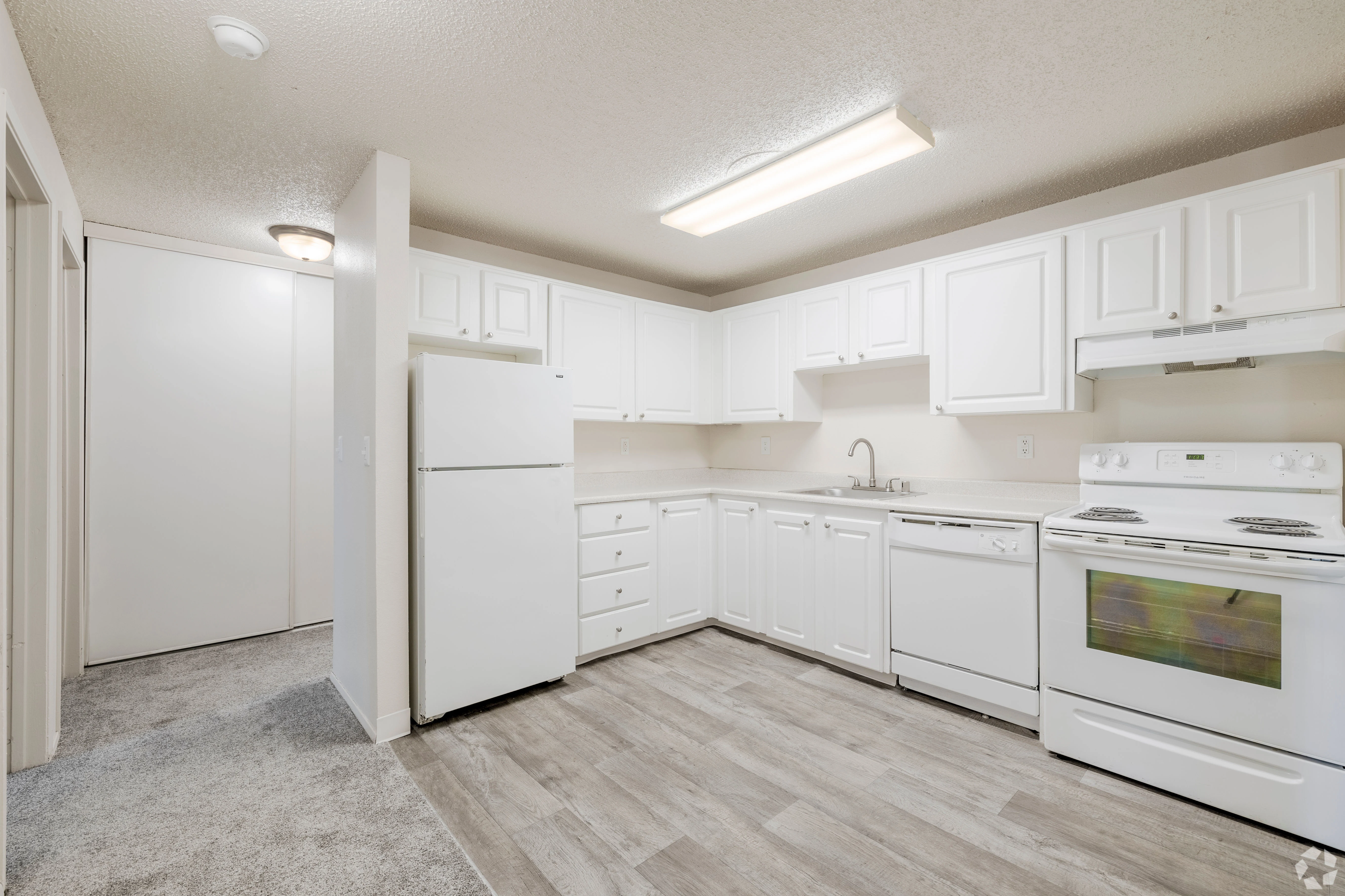 All white empty apartment with modern features and black accents