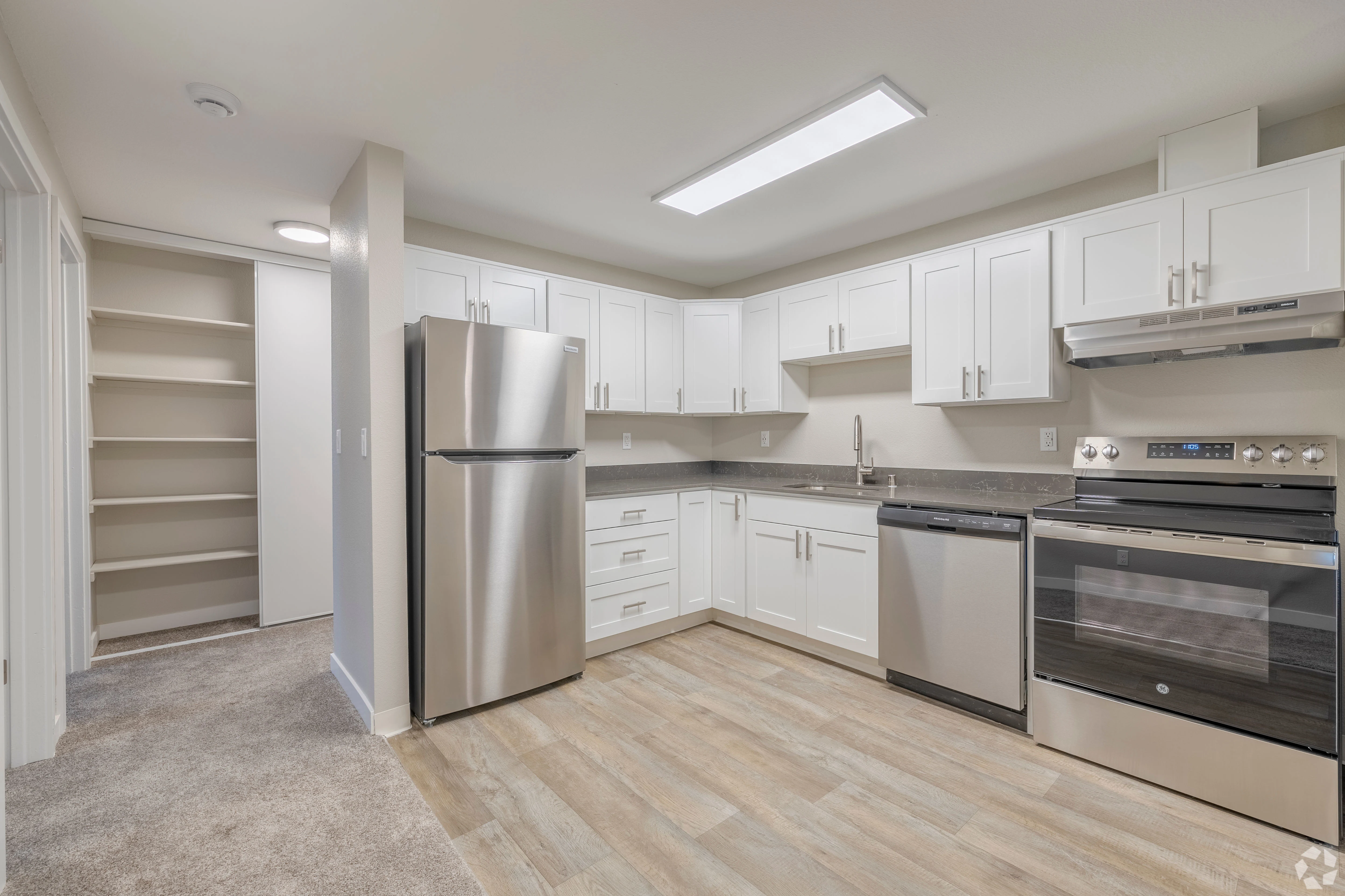 All white empty apartment with modern features and black accents