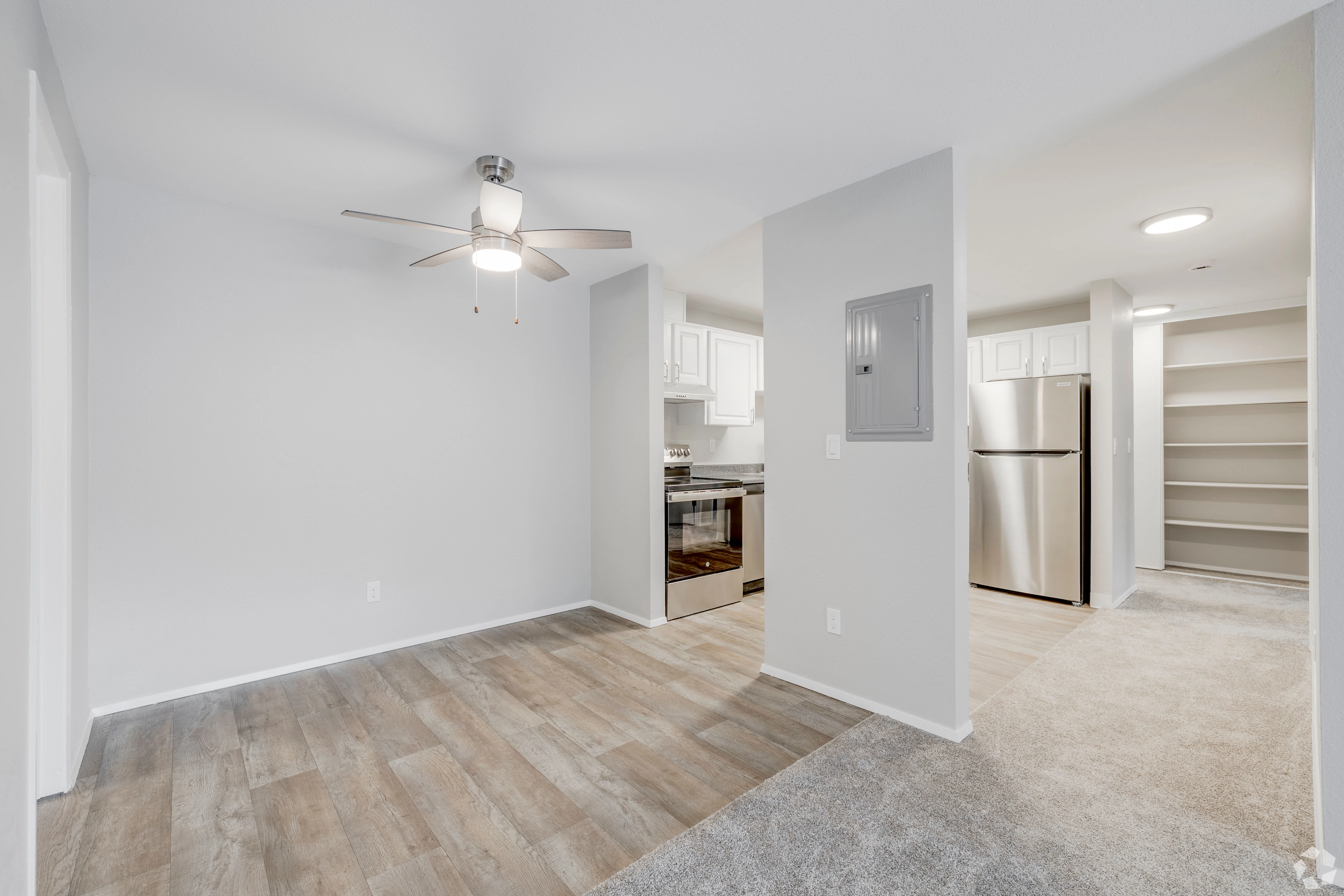 All white empty apartment with modern features and black accents