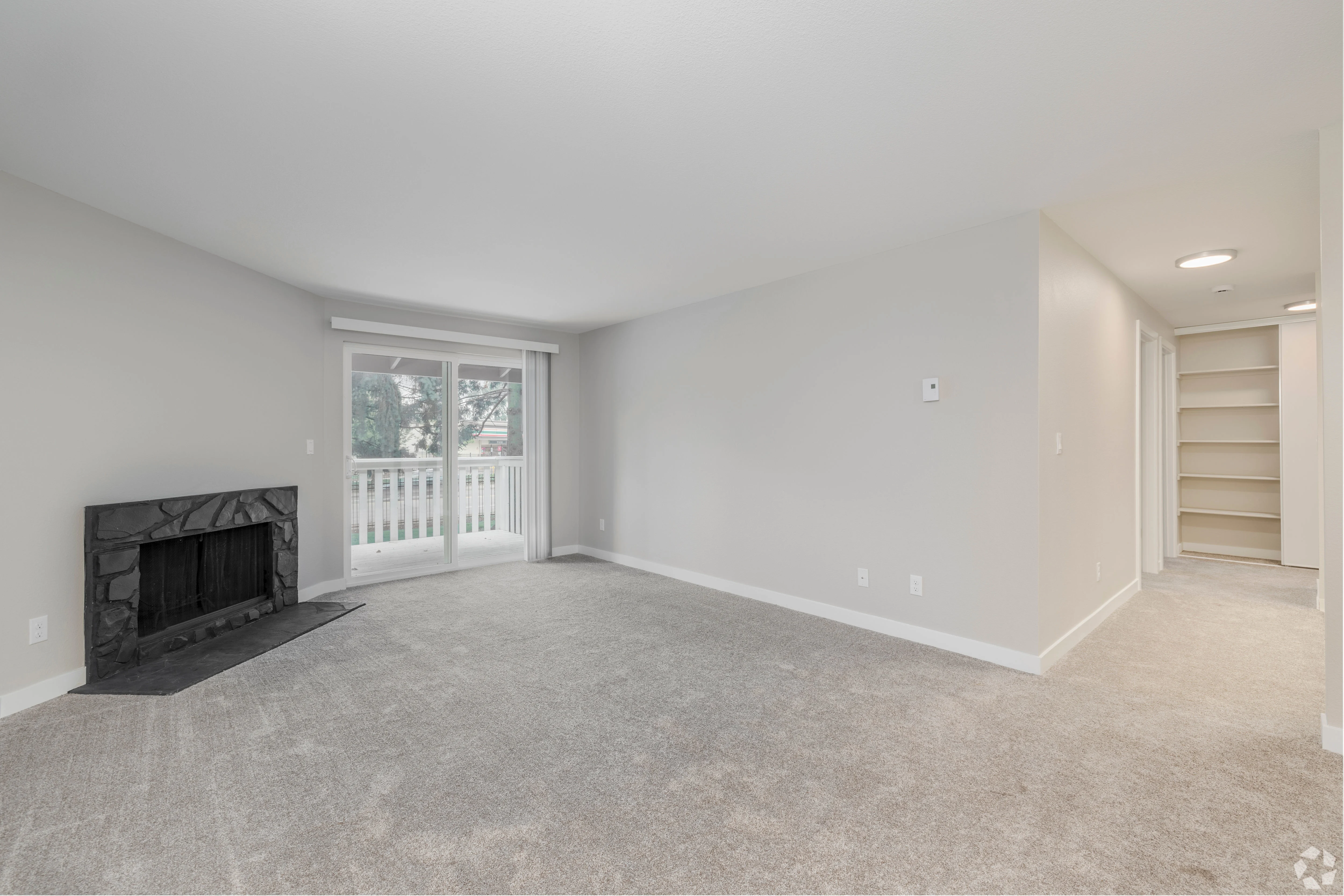 All white empty apartment with modern features and black accents