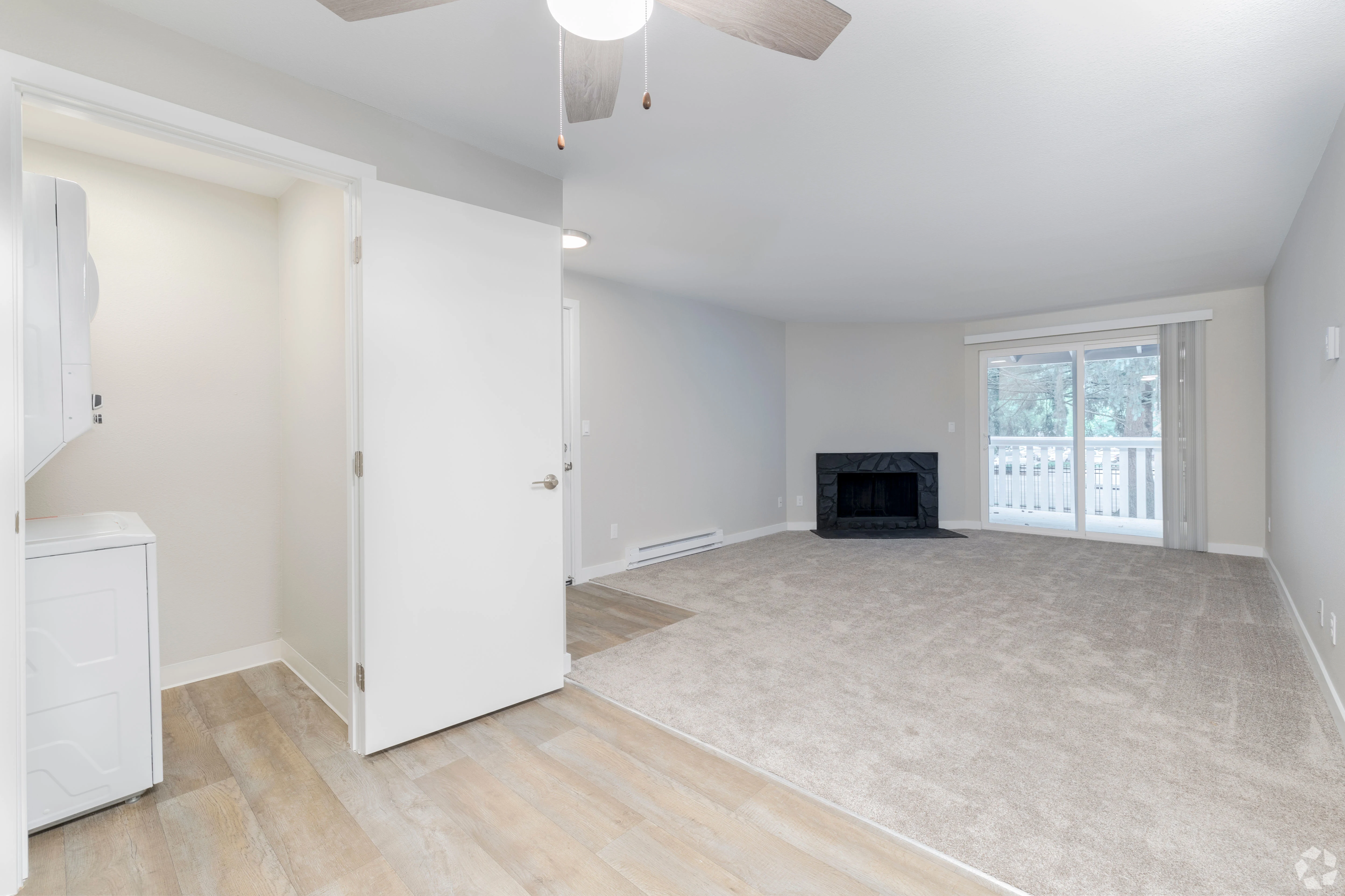 All white empty apartment with modern features and black accents