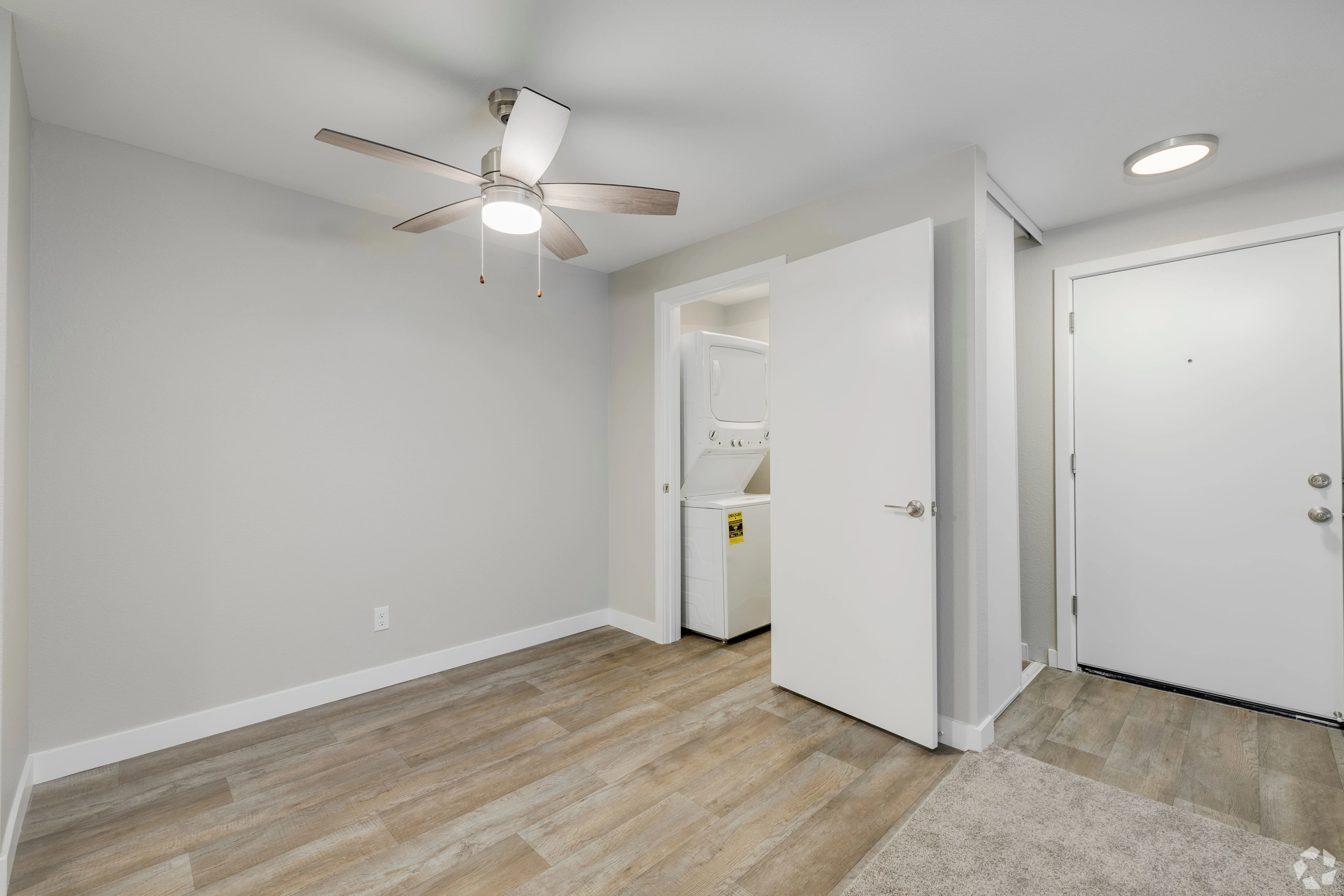 All white empty apartment with modern features and black accents