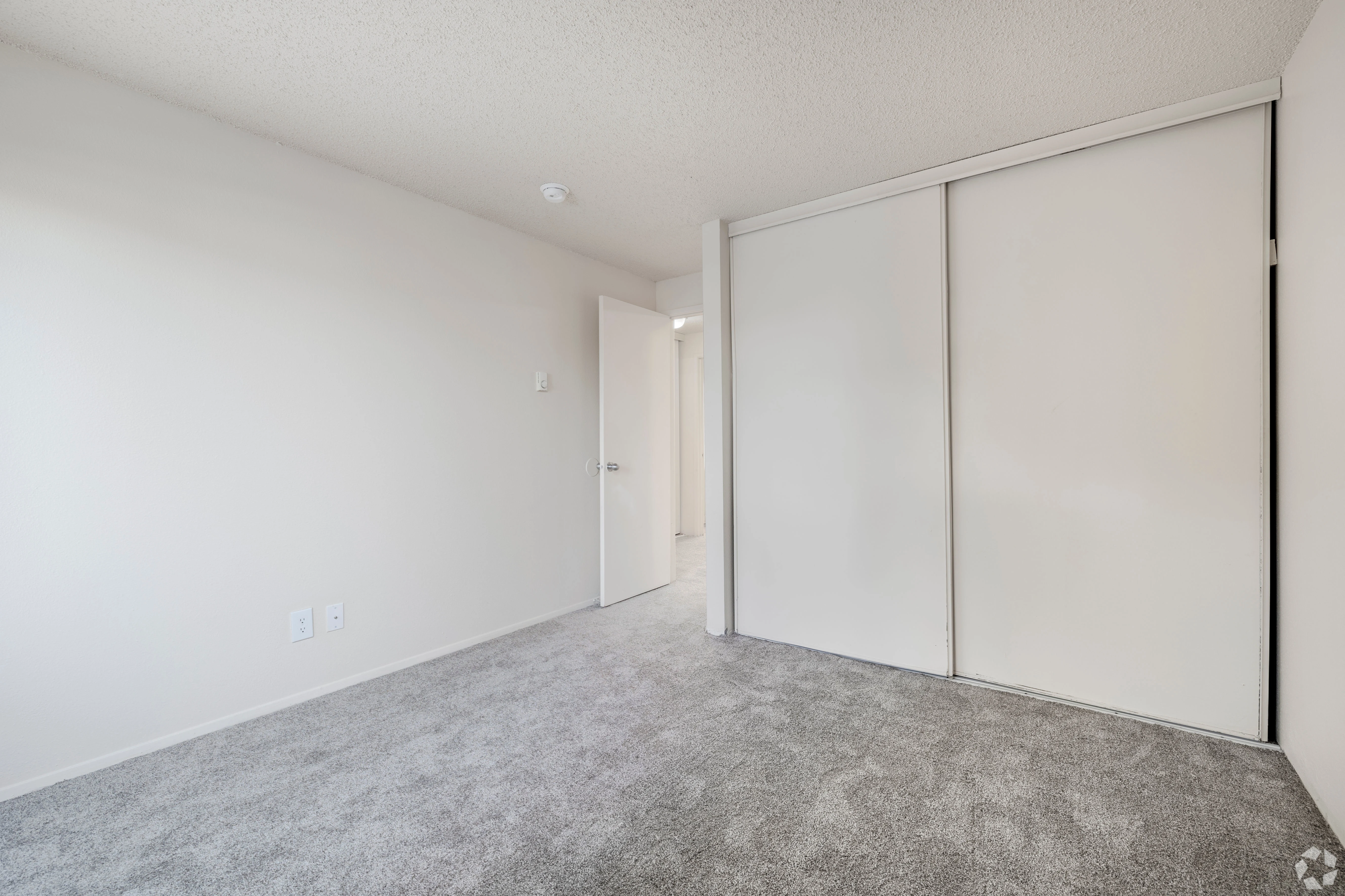 All white empty apartment with modern features and black accents