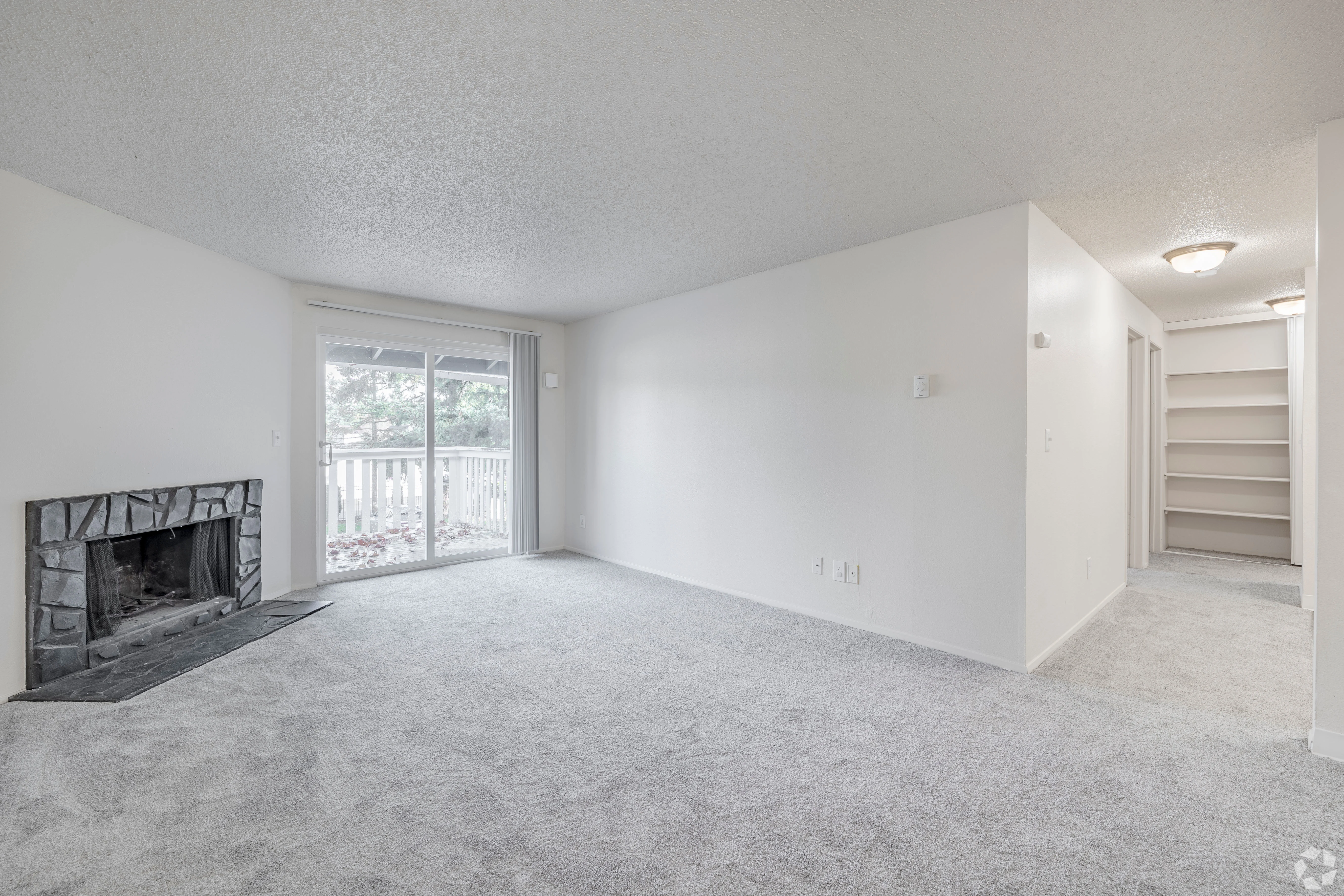 All white empty apartment with modern features and black accents