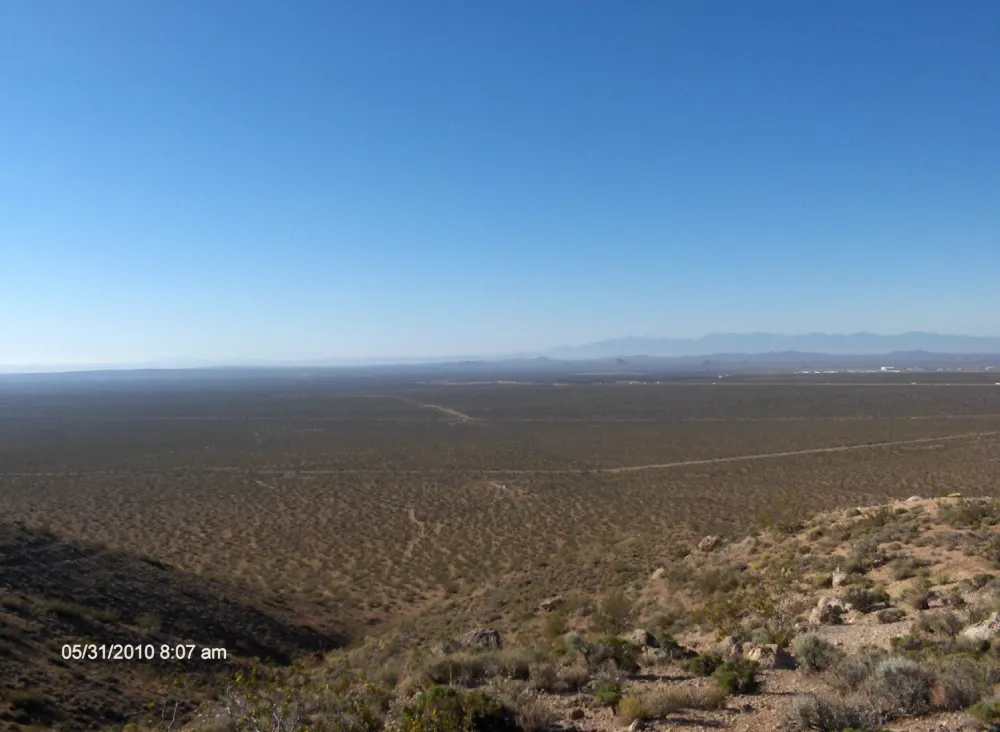 Standing atop a foothill overlooking the vast desert floor, this expansive landscape represents the bigger expanse where broader perspective uncovers opportunities that cannot be seen from a single point of view.