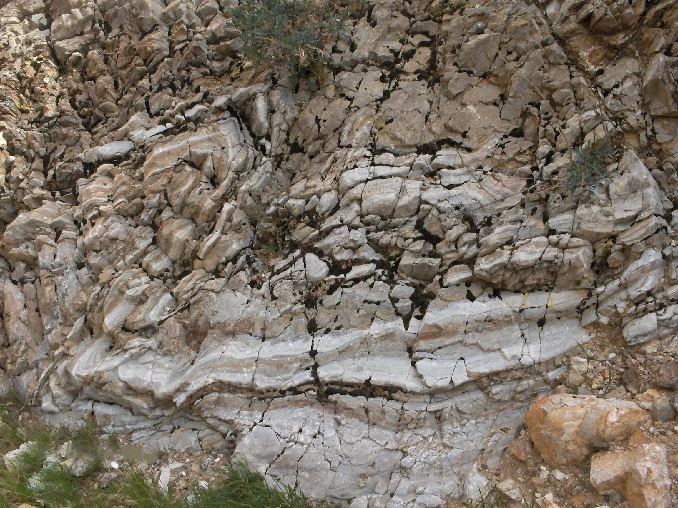 Layered sedimentary rock shaped by time, pressure, and natural forces, representing the enduring legacy built through resilience, growth, and a strong foundation that stands the test of time.
