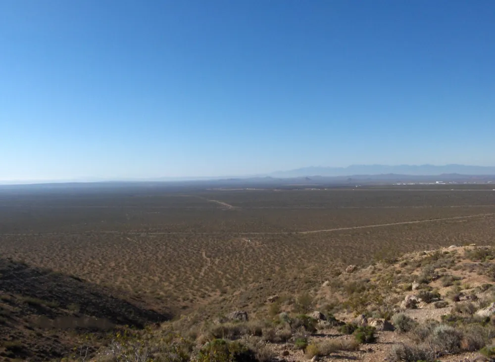 Standing atop a foothill overlooking the vast desert floor, this expansive landscape represents the bigger expanse where broader perspective uncovers opportunities that cannot be seen from a single point of view.