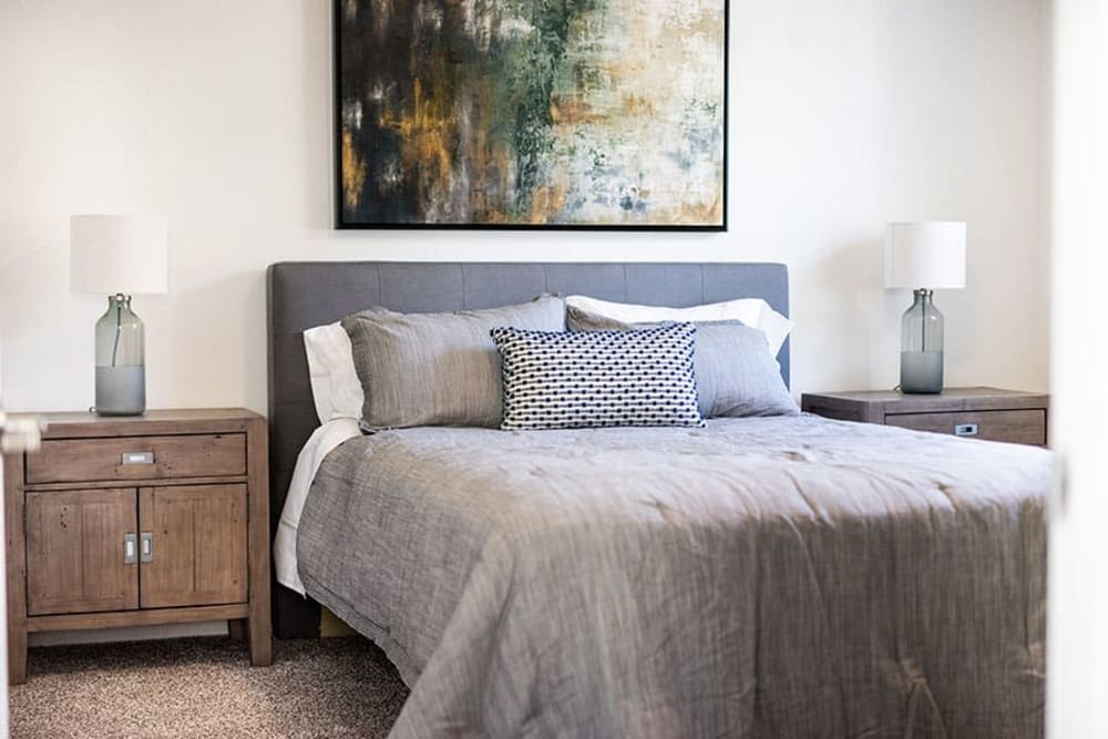 Bedroom with bed, bedside table, and wall art