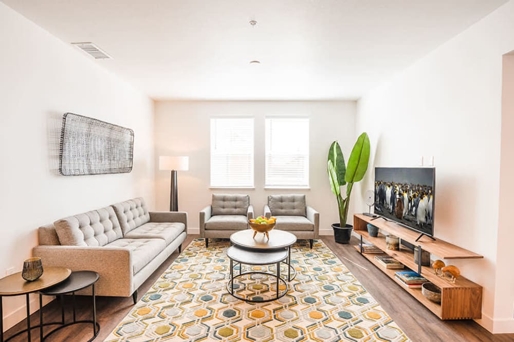 Living area with sofa, coffee tables, and large window