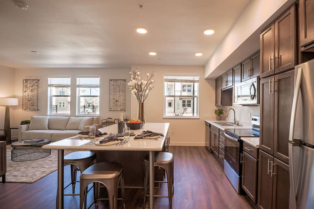 Kitchen with island, brown cabinets and stainless steel appliances