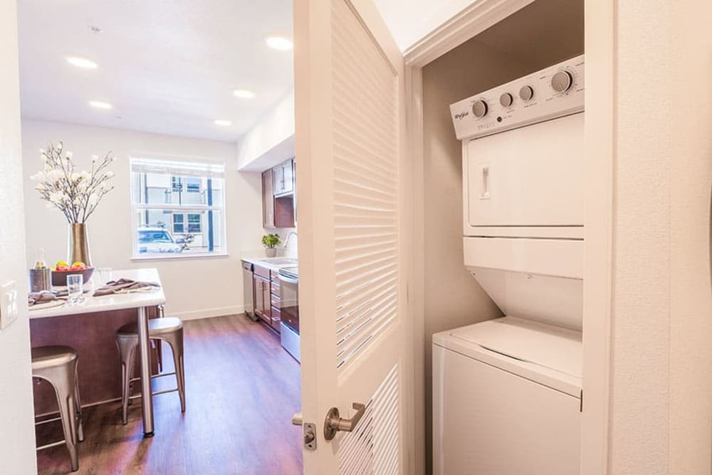 Laundry closet with white appliances