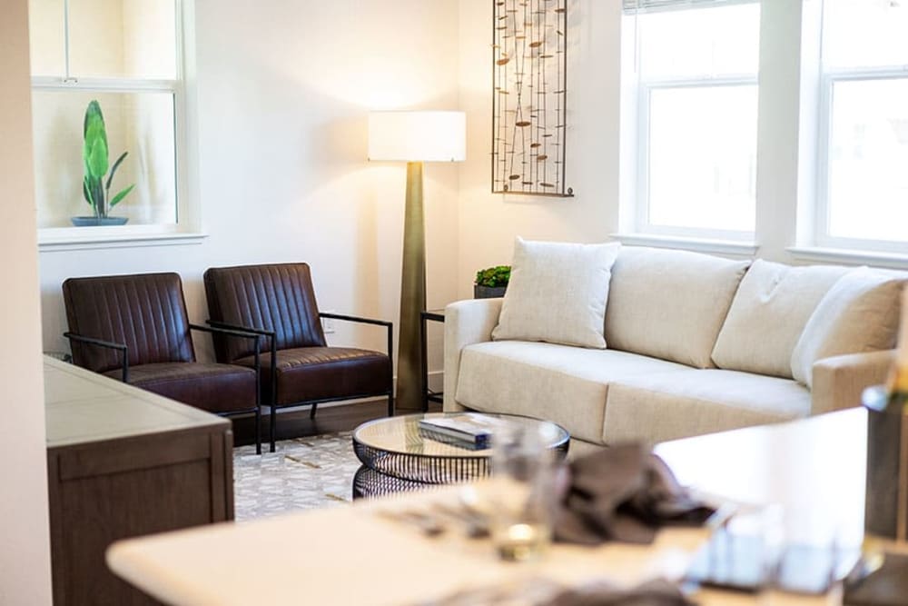 Living area with sofa, coffee tables, and large window