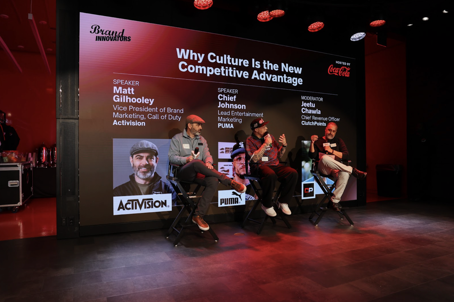 Three people sitting on a stage speaking to an audience. The title behind them states "Why culture is the new competitive advantage"