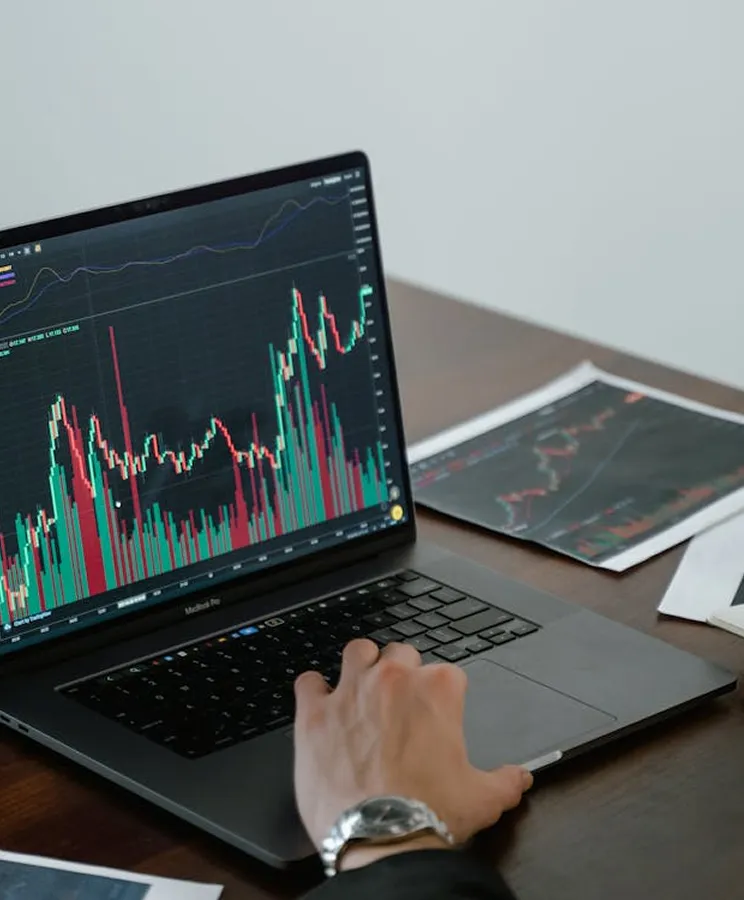 Financial charts and analytics on a laptop screen